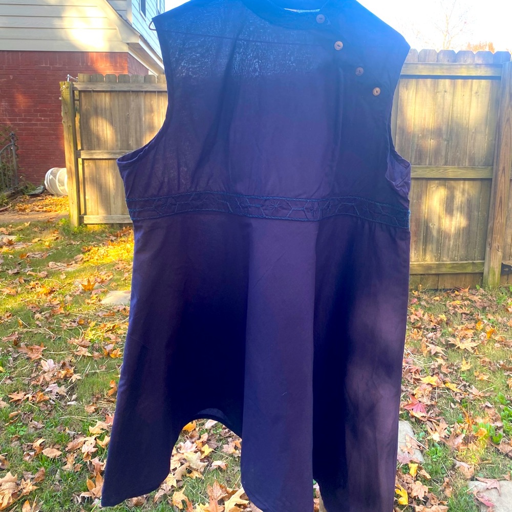 Handmade navy tunic with angled hem.